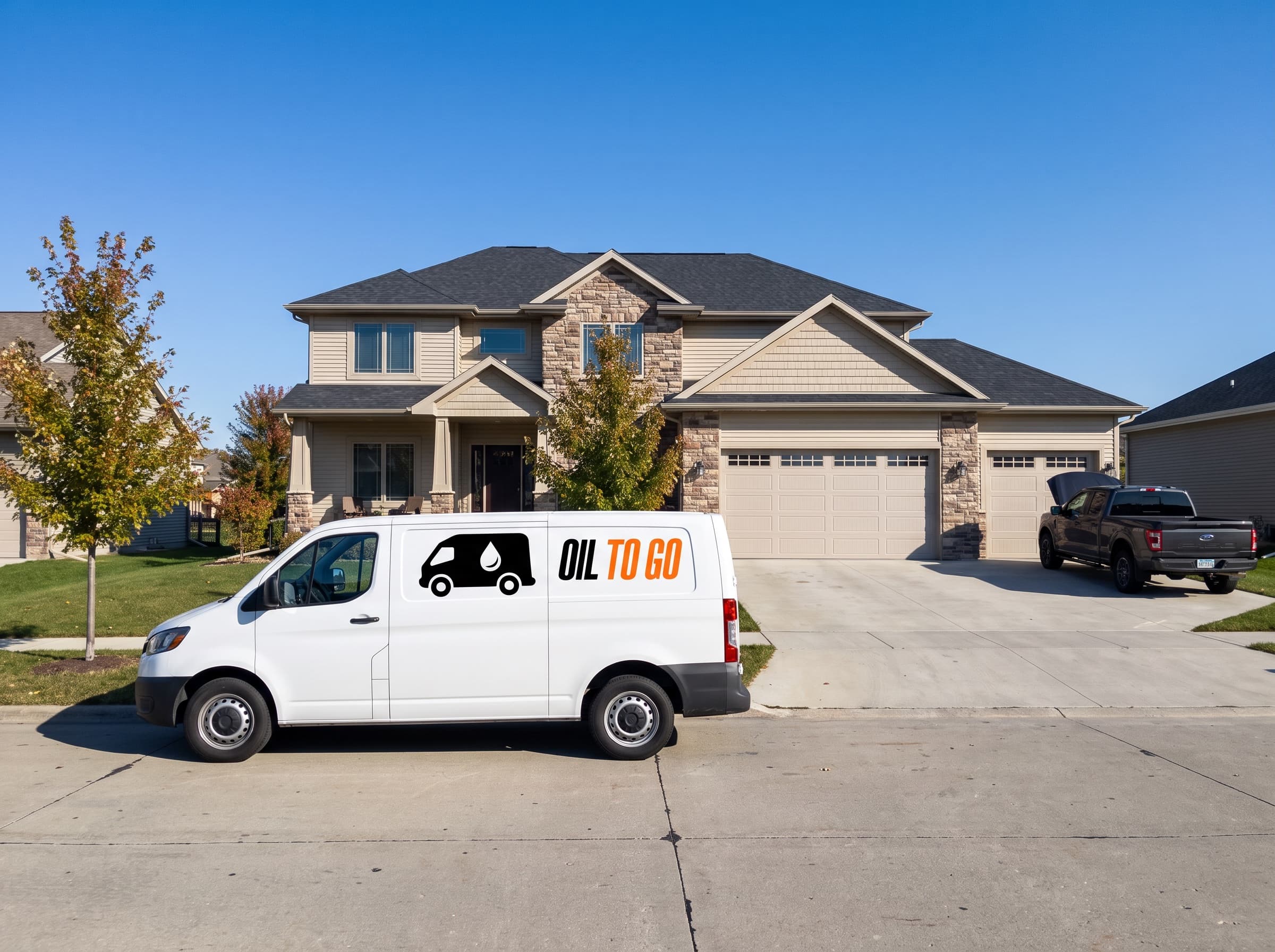 The Oil To Go van parked outside a newer two-story home with a three-car garage in Marion